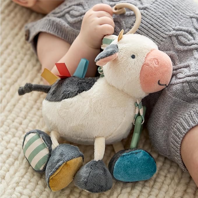 Itzy Ritzy Link & Love Toy for Stroller or Car Seat – Features Textured Ribbons, Crinkle Sounds, Clinking Rings & Silicone Teether – Designed for Ages 0 Months and Up (Cow)