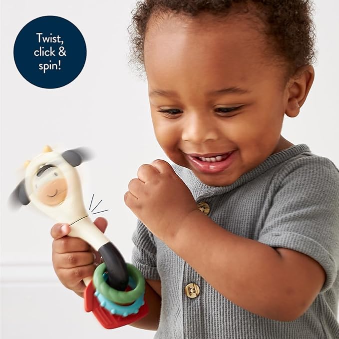 Itzy Ritzy Spinner Rattle Toy – Cow Design Sensory Teething Rattle Includes Spinning Face, Clicks, Rattles & Textured Teethers – Designed for Ages 3 Months and Up (Cow)