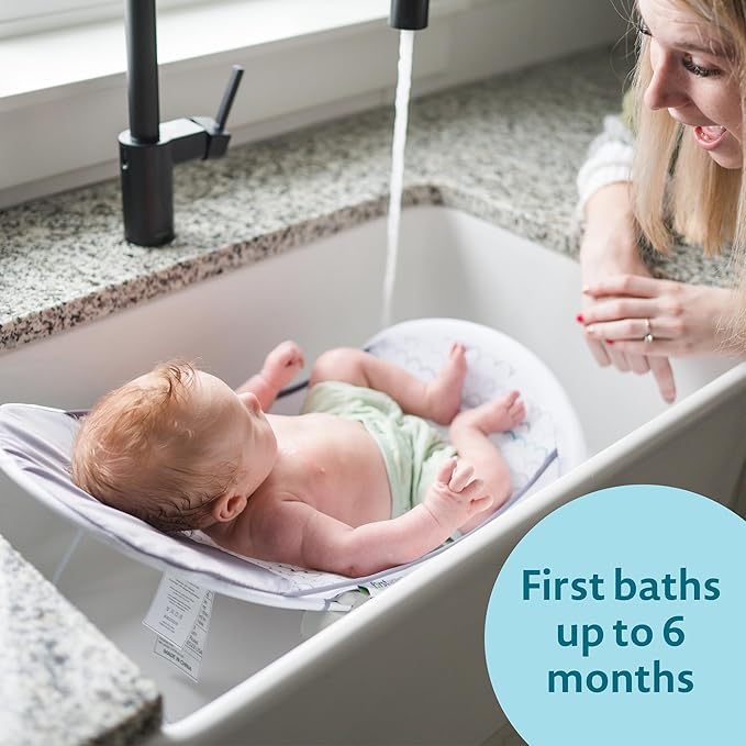 The First Years Sure Comfort Folding Baby Bather - Foldable Baby Bath Seat and Lounger for Home or On the Go - for Sink or Tub Use - Non-Slip Seat - For Up to 15 Lbs